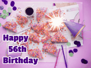 Happy Birthday Age 56 GIF, 56th Birthday GIF: A big paper sparkle highlights this animated birthday gif showing a birthday cake place setting with decorations.
