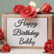 Happy Birthday Bobby GIF: An elegant gift box label animated gif with glitter flowing over the label and a name appearing that you can customize. The scene is decorated with roses