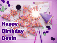 Happy Birthday Devin GIF: A big paper sparkle highlights this animated birthday gif showing a birthday cake place setting with decorations.